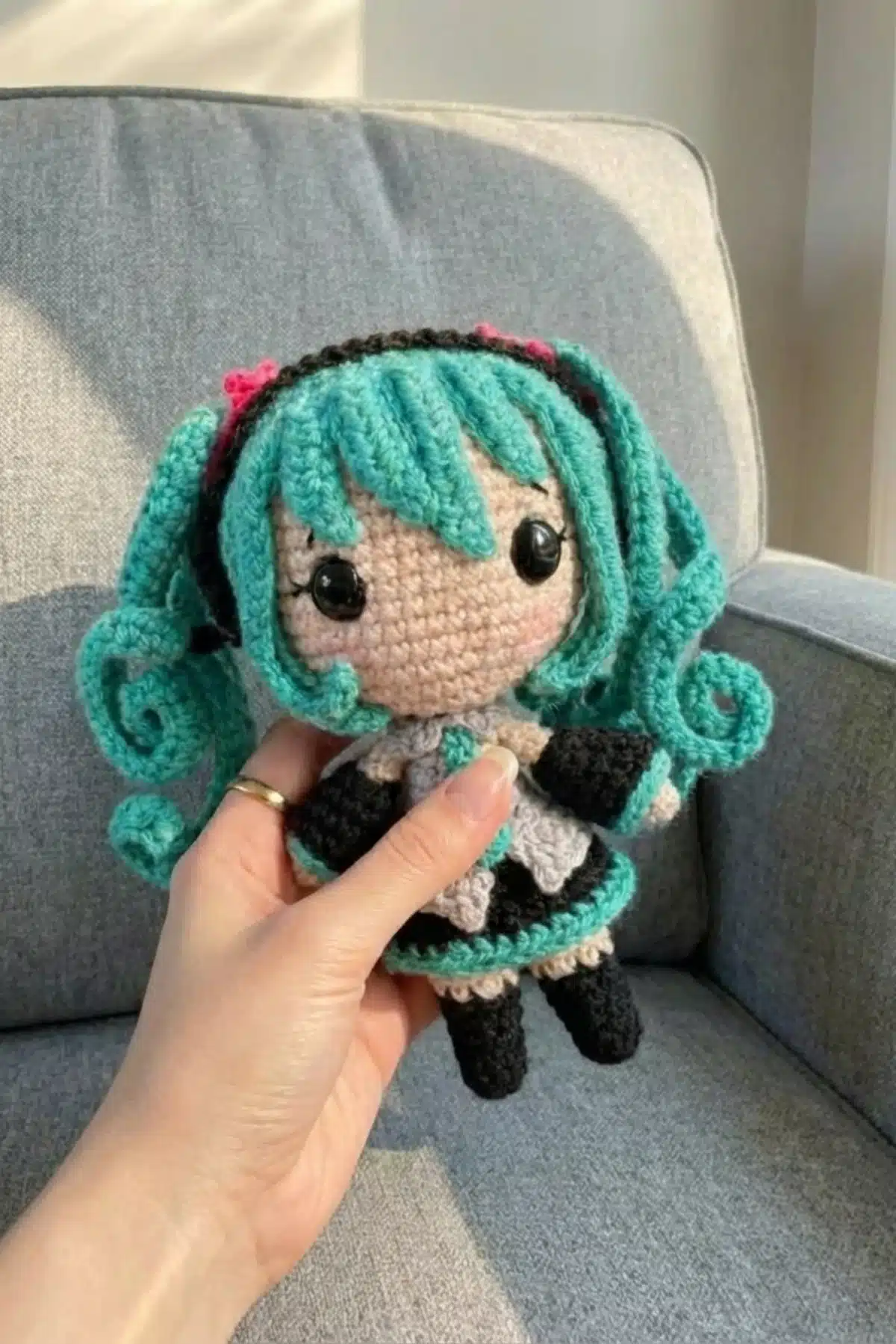 Hatsune Miku amigurumi crochet doll with teal pigtails and headphones