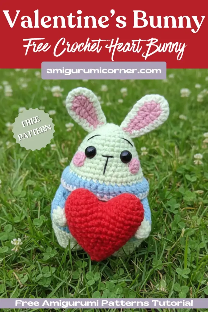 Handmade Valentine bunny amigurumi crochet pattern with red heart on outdoor stone surface in garden setting