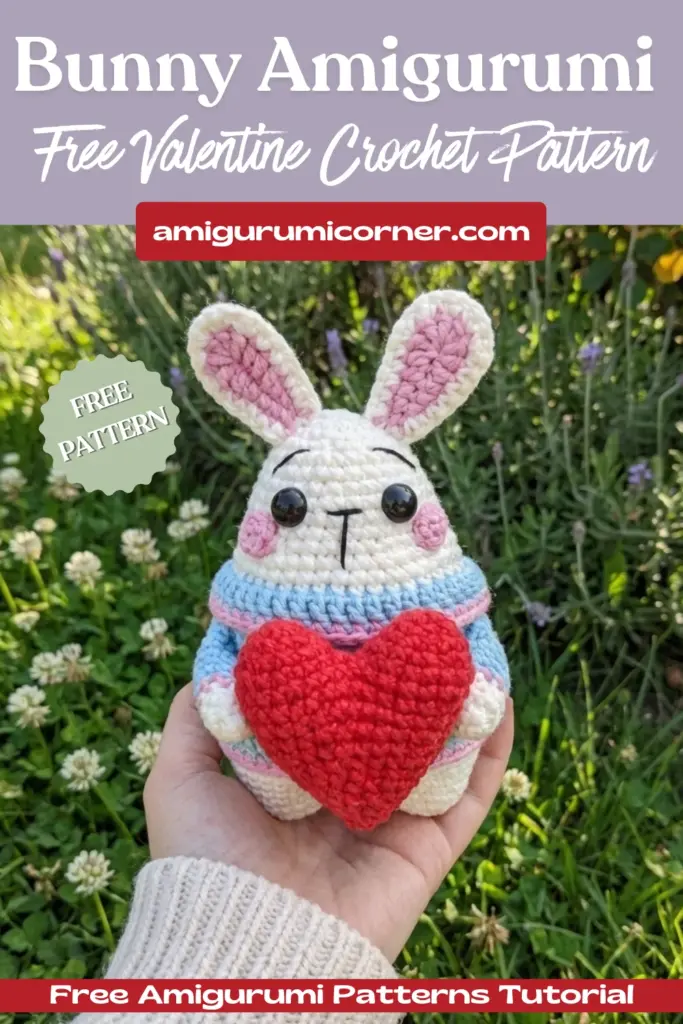 Bunny amigurumi free Valentine crochet pattern held in hand showing size of finished white bunny with red heart